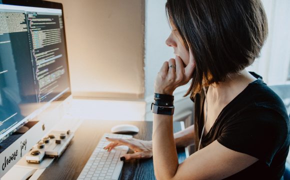 Photo of woman sitting at computer