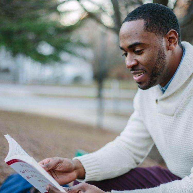 Student reading in park