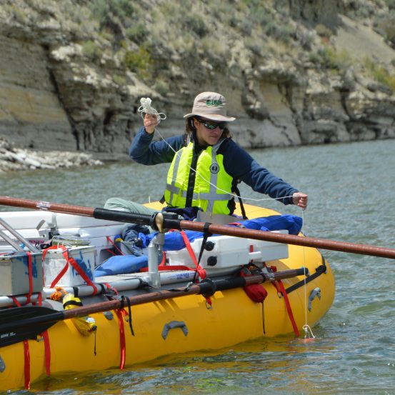 Photo of scientist rafting in river